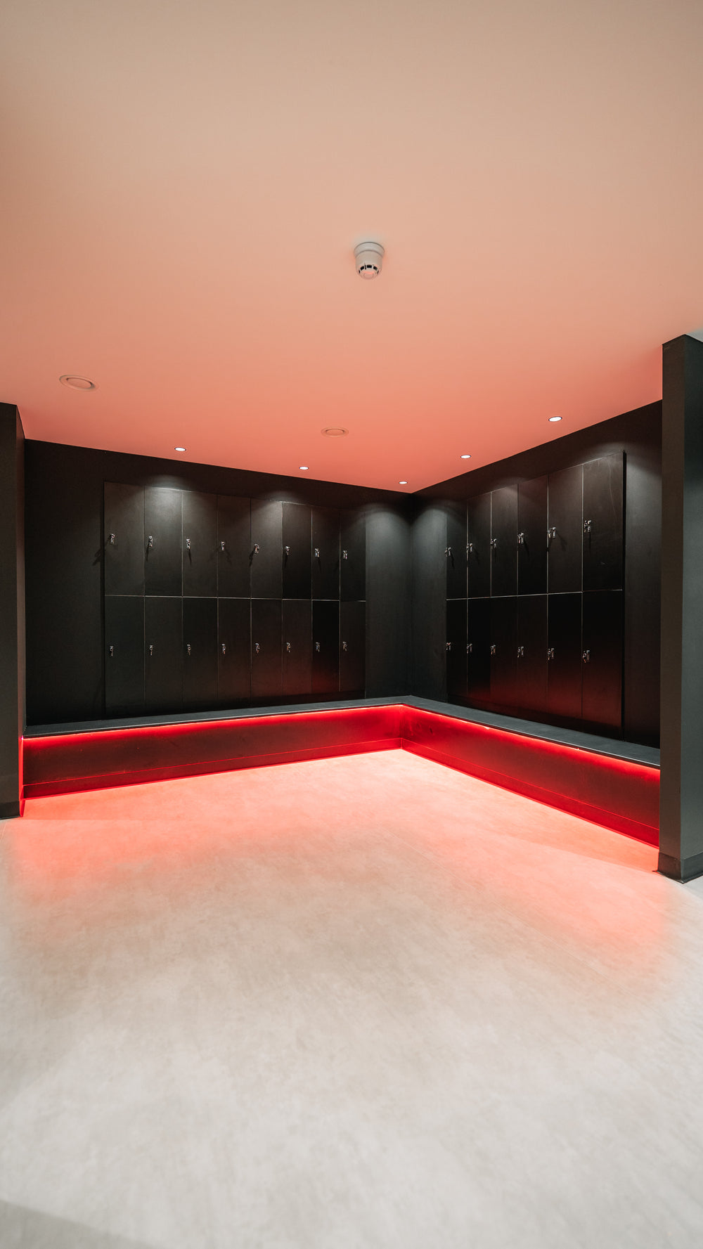 Dark fitted lockers with red lighting around the base